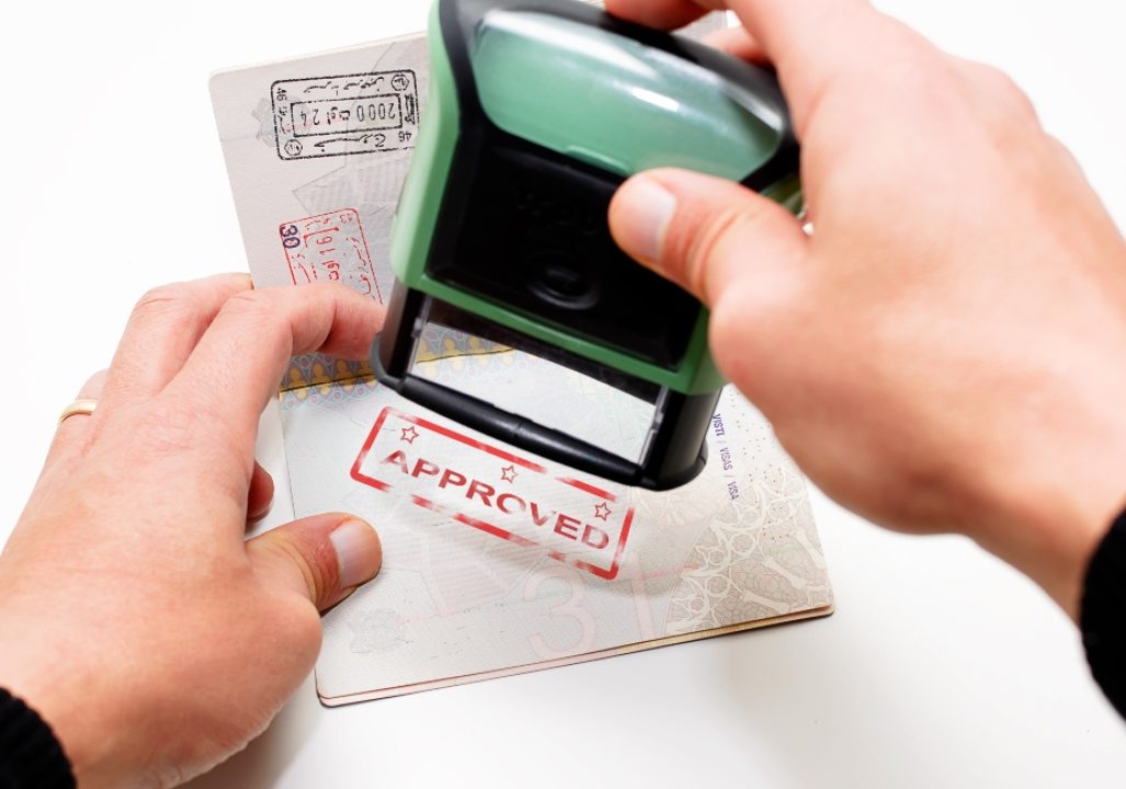 Stamping passport with red stamp approved