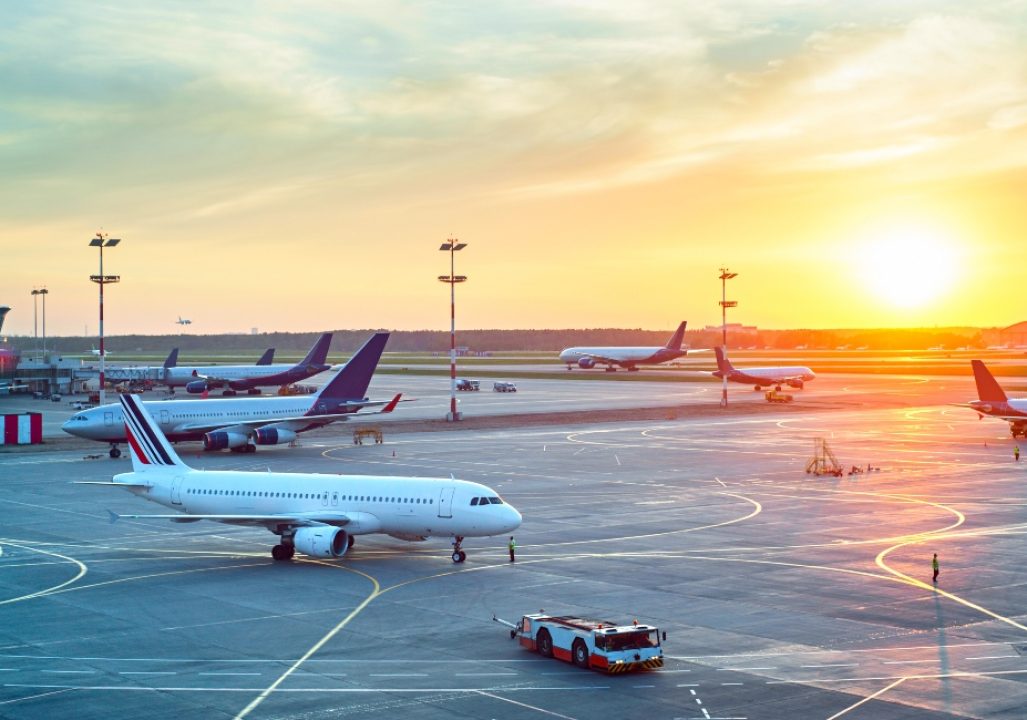 Airport with many airplanes at beautiful sunset