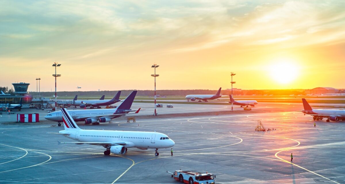 Airport with many airplanes at beautiful sunset