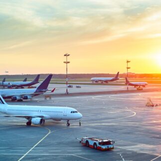 Airport with many airplanes at beautiful sunset