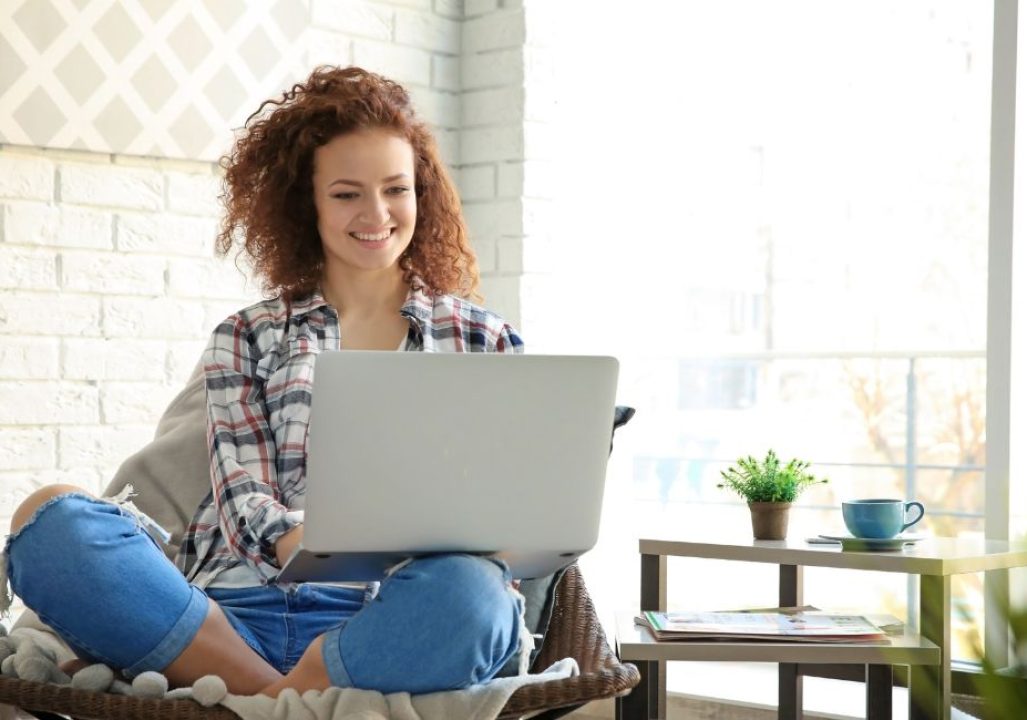 Young woman using laptop at home
