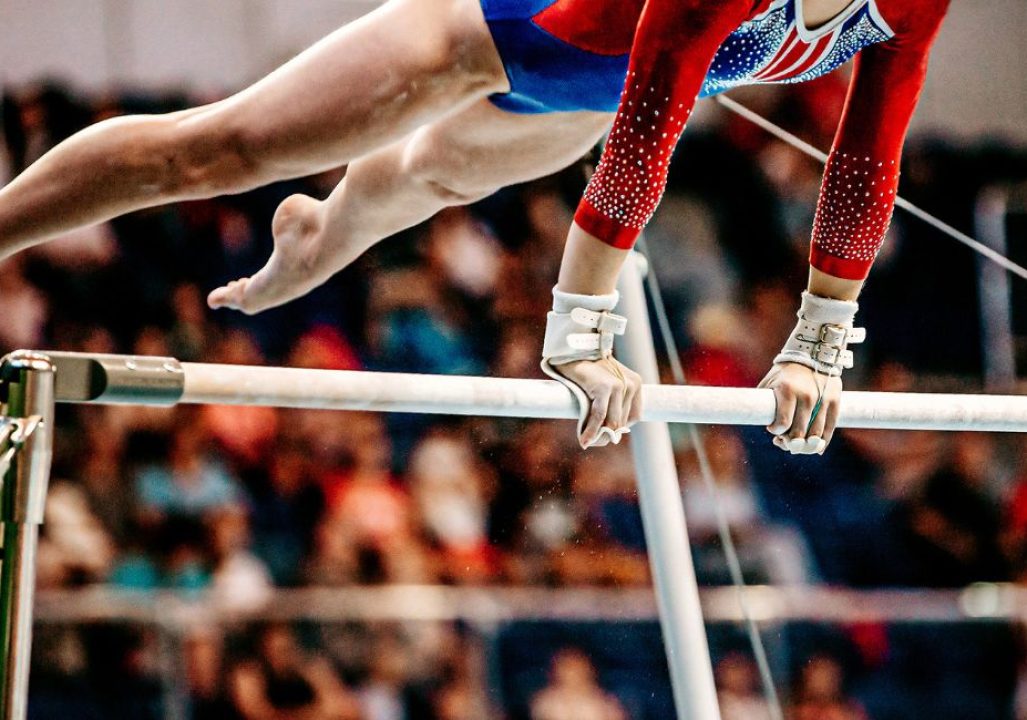 close-up body part female gymnast exercise on uneven bars in artistic gymnastics, sports summer games