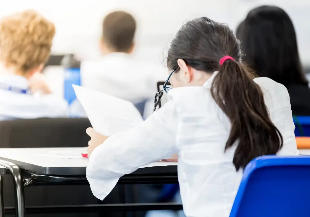 view of young female student at her looking at an assignment