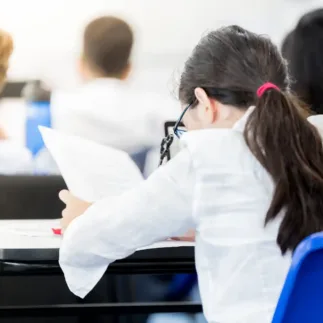 view of young female student at her looking at an assignment