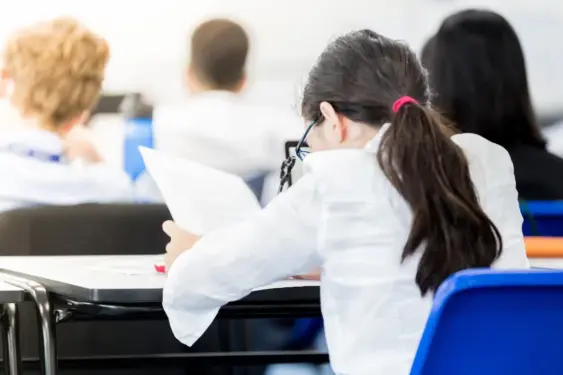 view of young female student at her looking at an assignment
