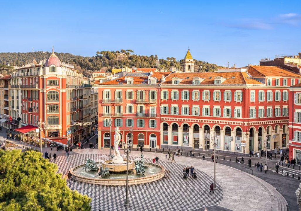 Aerial view of Place Massena square with red buildings and fountain in Nice, France