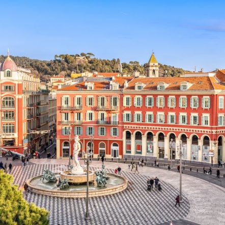 Aerial view of Place Massena square with red buildings and fountain in Nice, France