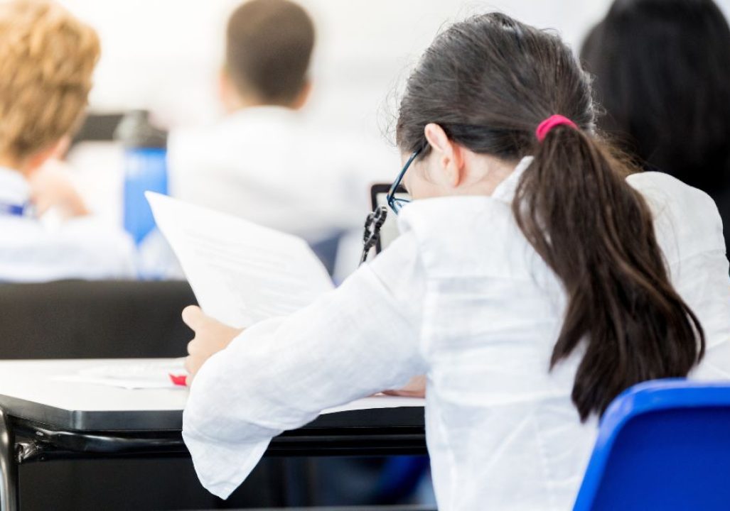 A young student studying in a classroom