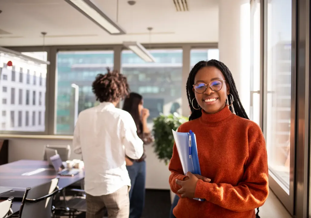 Student in a red sweater smiling at the camera
