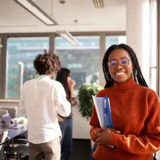 Student in a red sweater smiling at the camera