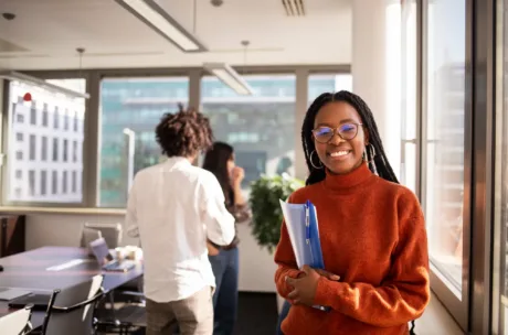 Student in a red sweater smiling at the camera