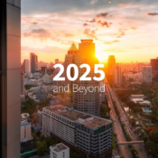 City skyline at sunset with tall buildings, lush trees, and a bustling road. Text reads 