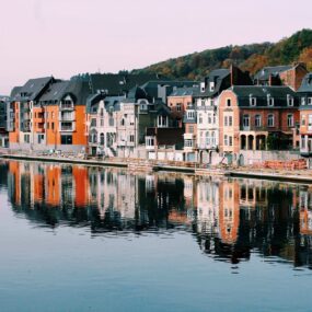 colorful houses along the Meuse River in Dinant, Belgium.
