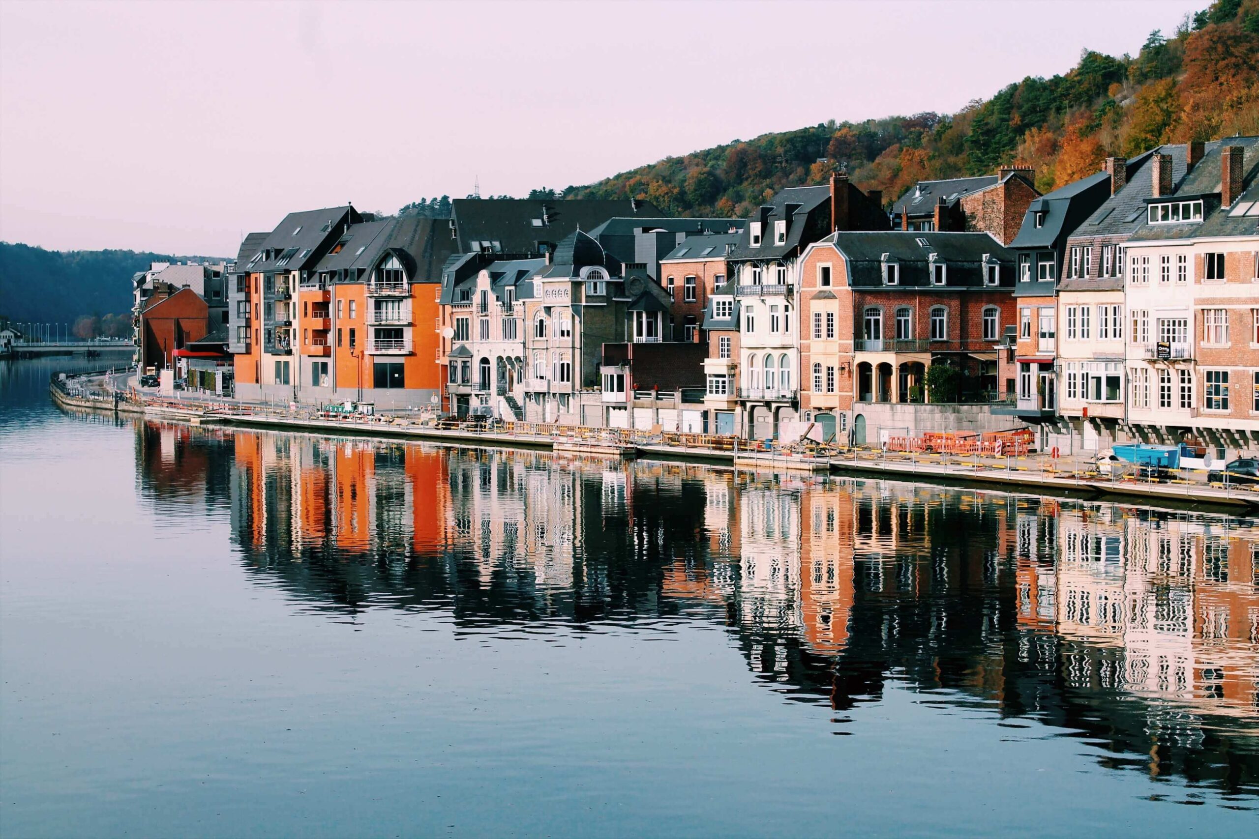 colorful houses along the Meuse River in Dinant, Belgium.