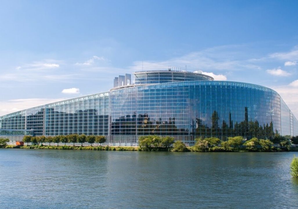 The European Parliament. A large glass building on the waterfront.