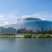 The European Parliament. A large glass building on the waterfront.