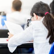 Person at a desk filling out paperwork.