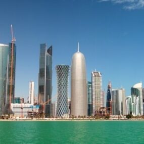 Qatar, modern skyline with distinctive skyscrapers along a waterfront.