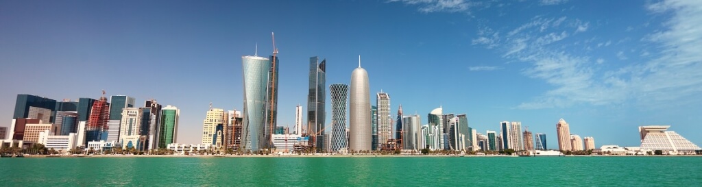 Qatar, modern skyline with distinctive skyscrapers along a waterfront.