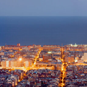 city of Barcelona at dawn, illuminated by city lights