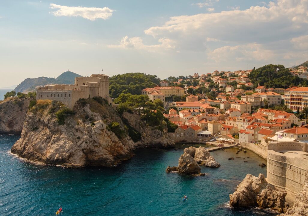 City of Dubrovnik, Croatia orange-tiled roofs, historic city walls, and Fort Lovrijenac perched on a cliff overlooking the Adriatic Sea.