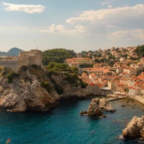 City of Dubrovnik, Croatia orange-tiled roofs, historic city walls, and Fort Lovrijenac perched on a cliff overlooking the Adriatic Sea.