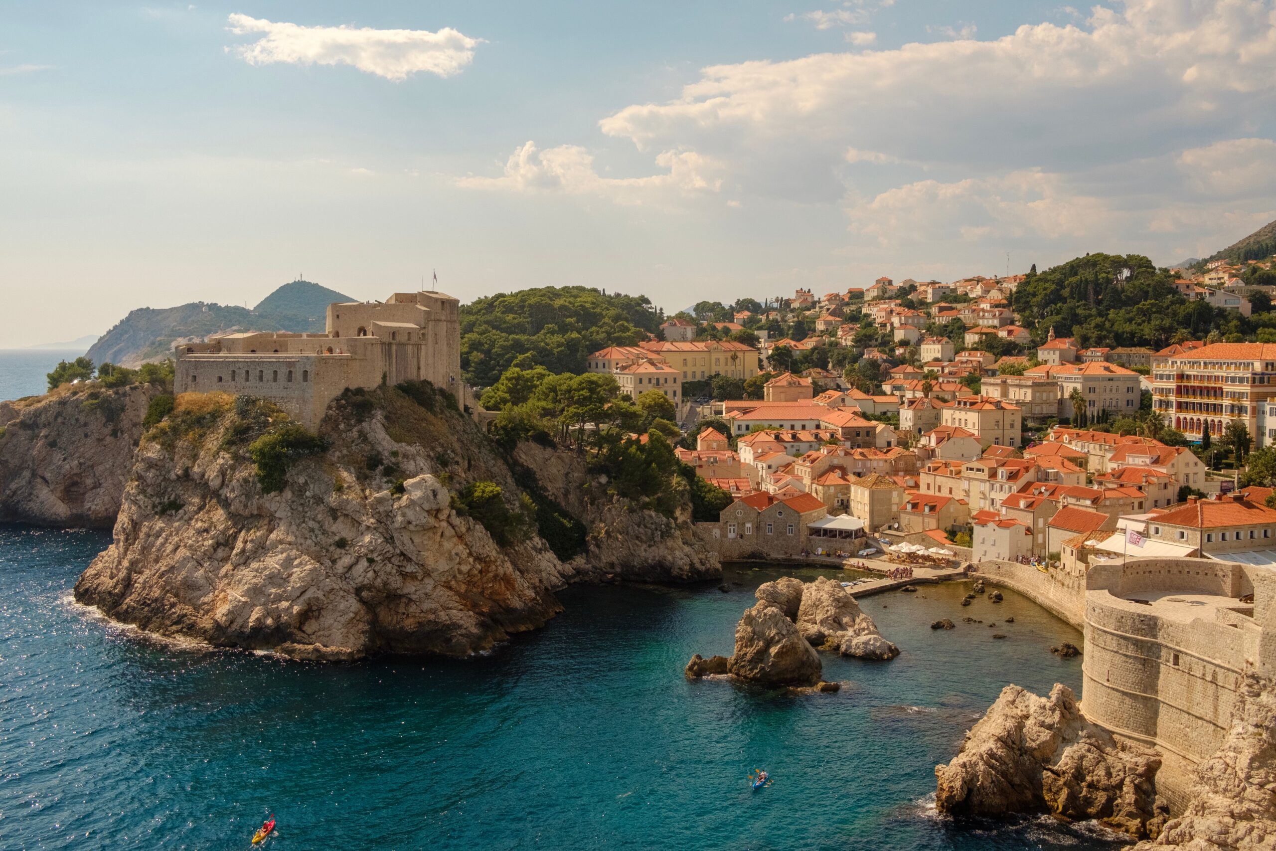 City of Dubrovnik, Croatia orange-tiled roofs, historic city walls, and Fort Lovrijenac perched on a cliff overlooking the Adriatic Sea.