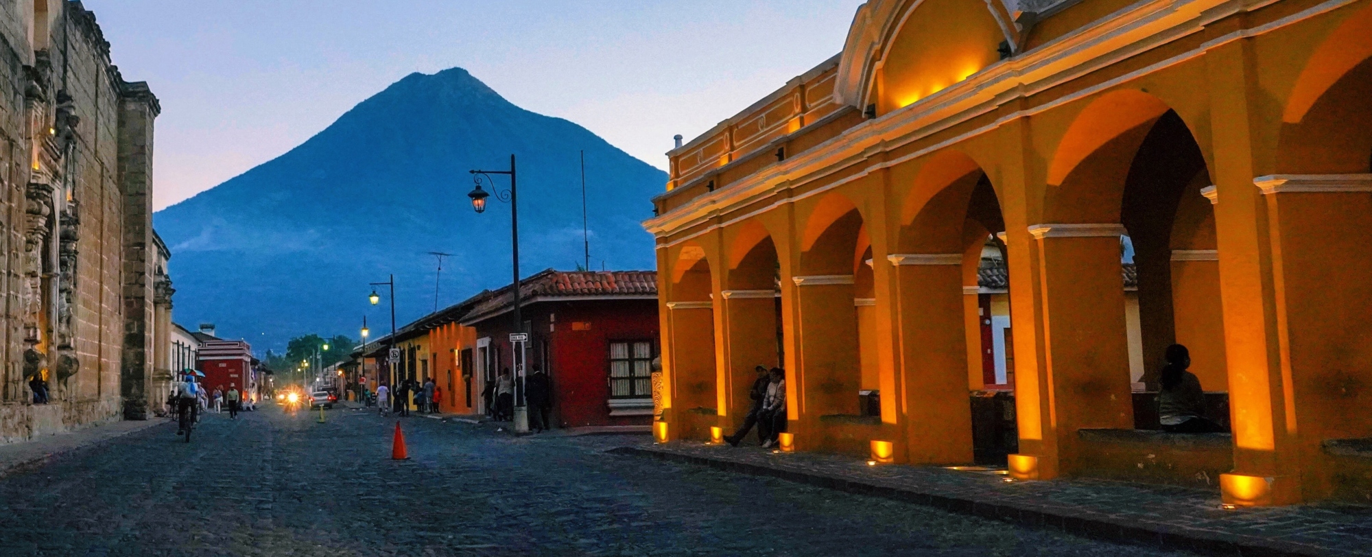 Antigua Guatemala, Guatemala featuring colonial architecture with cobblestone streets and a volcano in the background.