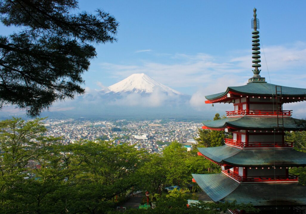 view of historical building in Japan with Mount Fuji in the background