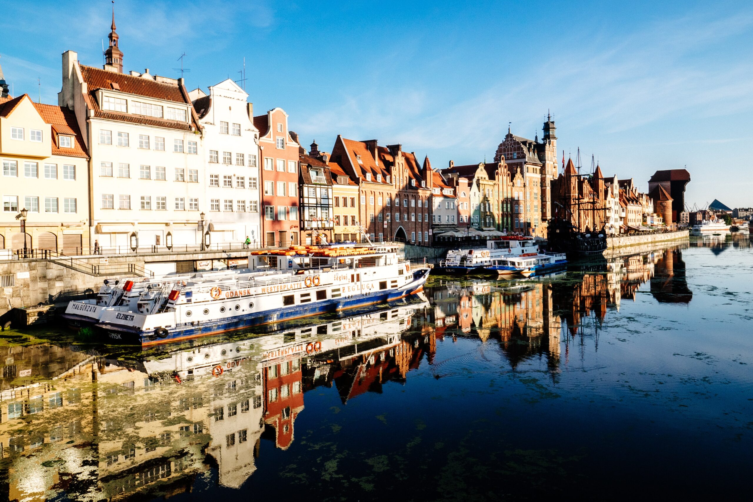Poland, It features a picturesque waterfront with colorful, historic buildings, often referred to as 