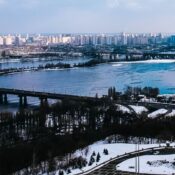 Ukraine, a wide river, with several bridges spanning it, and a cityscape with many buildings on both banks.