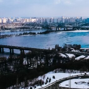 Ukraine, a wide river, with several bridges spanning it, and a cityscape with many buildings on both banks.