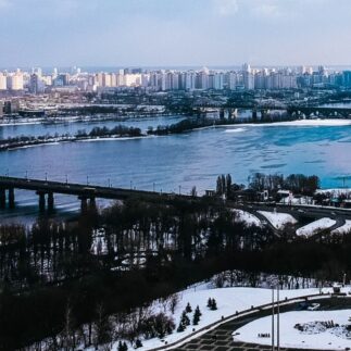 Ukraine, a wide river, with several bridges spanning it, and a cityscape with many buildings on both banks.