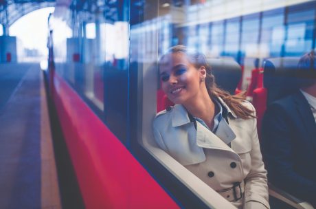 smiling woman sitting on a train