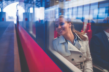 smiling woman sitting on a train