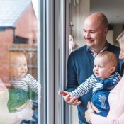 Smiling parents at home with baby