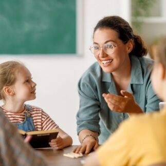 Happy kids and teacher at school