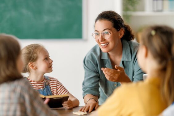 Happy kids and teacher at school