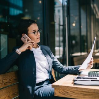 Busy female calling on mobile phone during remote work