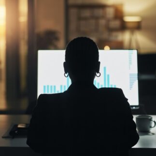 Business person, computer screen and night at office with finance graphs