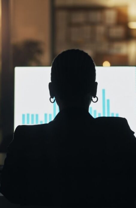 Business person, computer screen and night at office with finance graphs